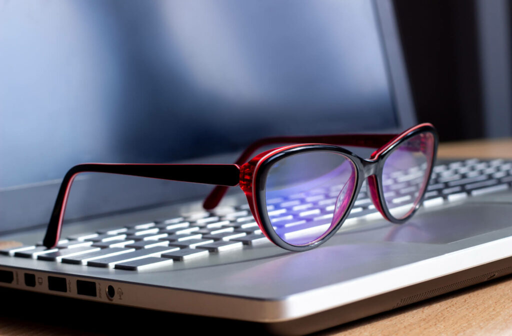 A pair of blue light glasses on a laptop.